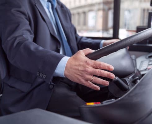 A coach bus driver behind the wheel